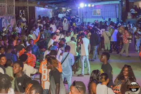 A wide view of the Hood Party crowd and stage lights