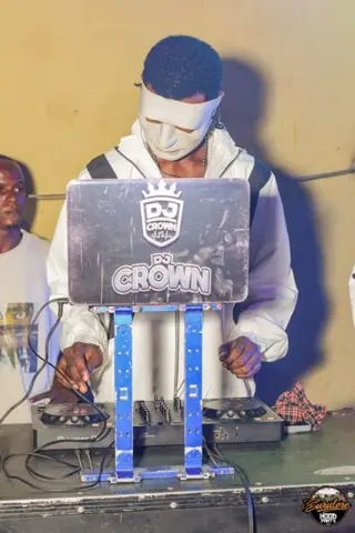 The DJ working behind a laptop at Hood Party