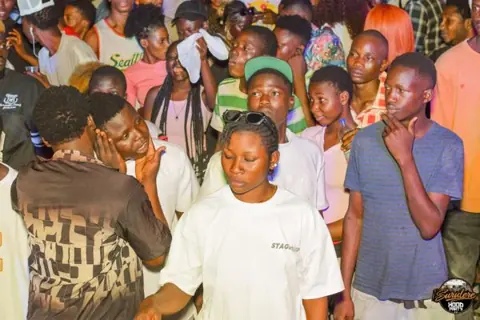 A crowd gathered in front of the performance area